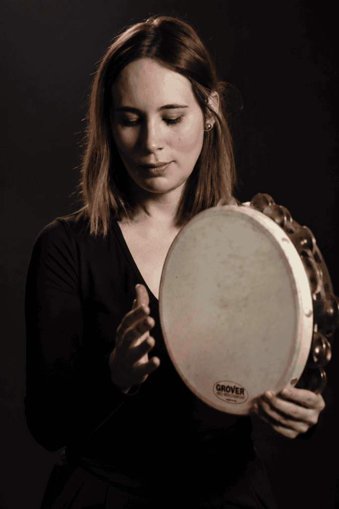 Lise Duarte Nuñez holding a Grover Pro tambourine, an instrument from her artistic partnership.